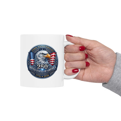 Woman's hand holding the patriotic bald eagle 250th anniversary white mug, design facing the camera