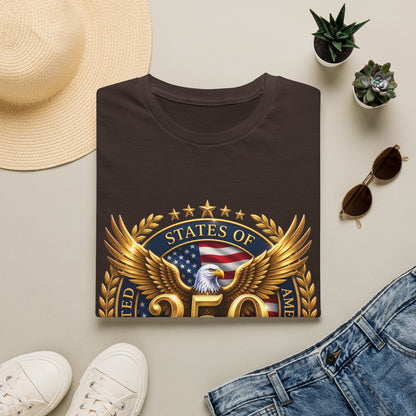250th Anniversary USA gold eagle crest design on a dark brown t-shirt, folded flat lay with a sun hat, plants and jeans