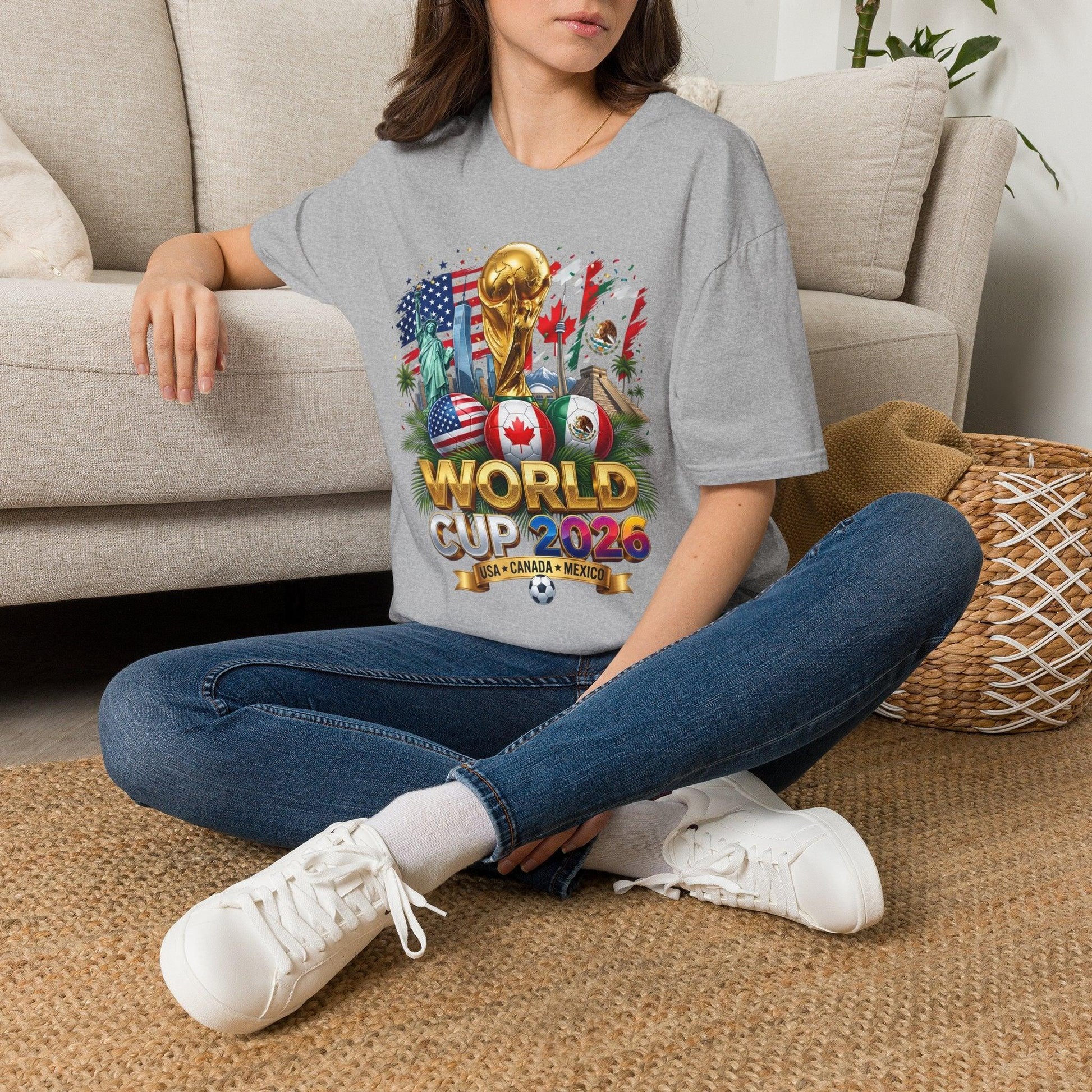 Gray World Cup 2026 trophy t-shirt worn by a woman sitting on the floor at home